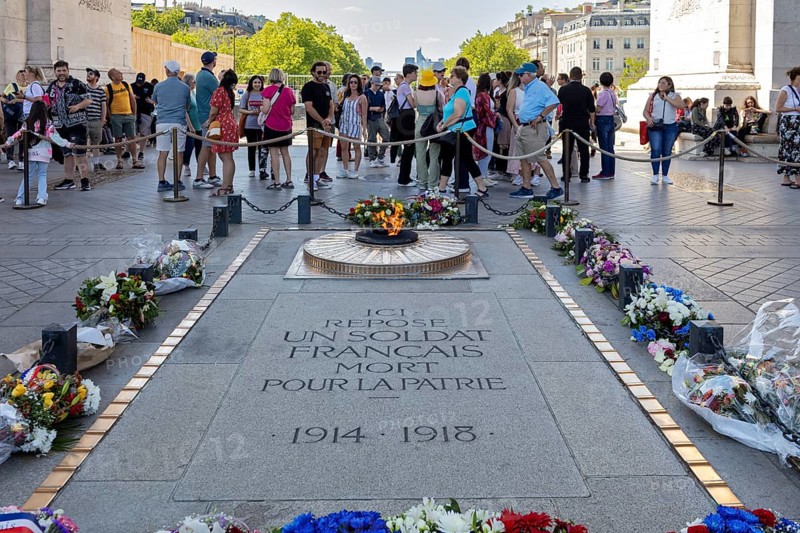 Monument with floral wreaths and people in honour of a fallen soldier in Paris, Paris