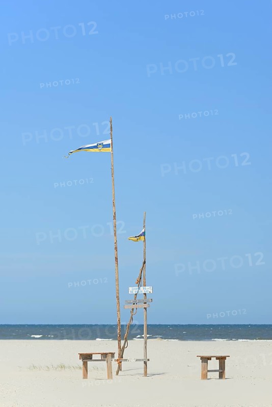 Pile dwelling on the extensive sandy beach, wooden piles with Juist flag, wooden planks with inscriptions, wooden benches, blue sky, North Sea, Juist, East Frisian Islands, Lower Saxony, Germany, Europe