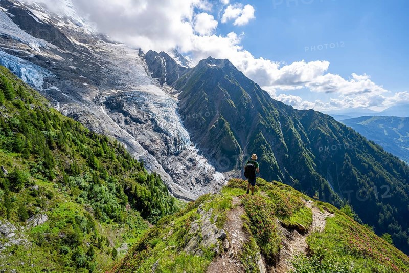 Mountaineer in front of impressive mountain landscape with glacier, view of glacier Glacier de Taconnaz, hike La Jonction, Chamonix, Haute-Savoie, France, Europe
