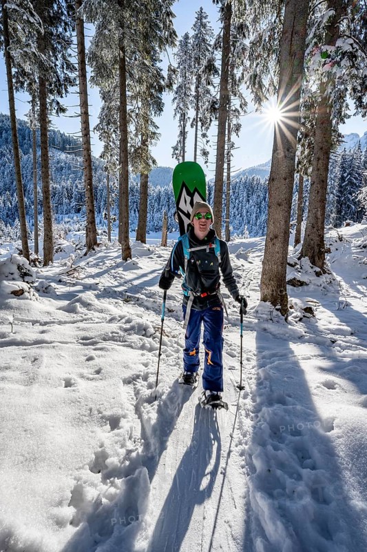 Snowshoe hiker in snowy winter forest, Sonnenstern, Ascent to Teufelstättkopf, Snowy mountain landscape, Ammergau Alps, Bavaria, Germany, Europe