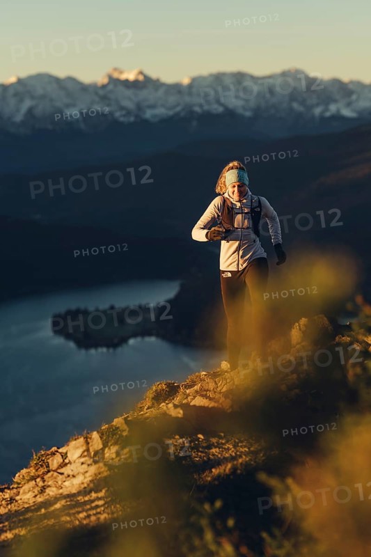 Trail running in autumn on the Jochberg on Lake Walchensee against the wonderful backdrop of the Alps, Bavaria, Germany, Europe