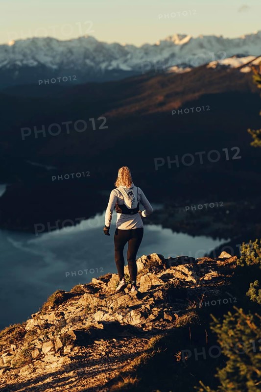 Trail running in autumn on the Jochberg on Lake Walchensee against the wonderful backdrop of the Alps, Bavaria, Germany, Europe