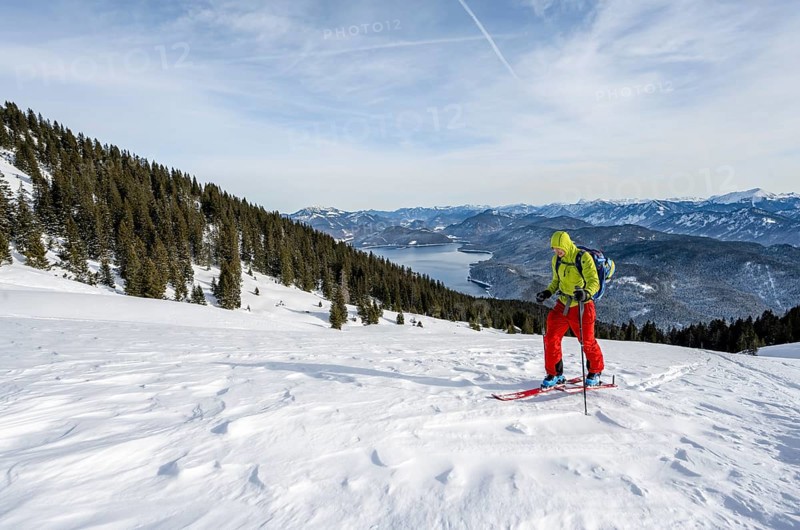 Ski tourers climbing Simetsberg, view of Walchensee, Estergebirge, Bavarian Prealps, Bavaria Germany