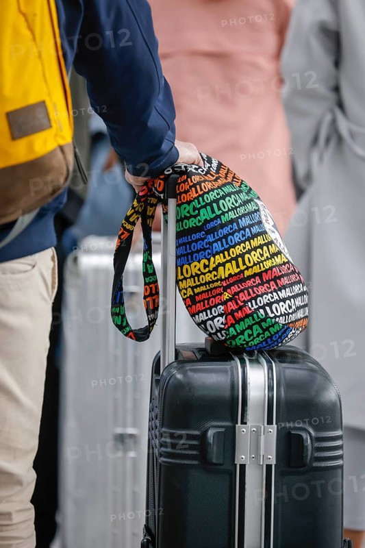 Düsseldorf, North Rhine-Westphalia, Germany - Düsseldorf Airport, Easter holidaymakers at the Condor check-in counter on their way to Majorca during the corona pandemic, hand luggage with Majorca written on it, in front of the flight to Spain and also in front of the return flight to Germany, air travellers must present a negative corona test