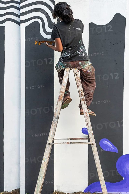 Indian artist painting a wall during the international contemporary art exhibition Kochi-Muziris Biennale, Fort Cochin, Kochi, Kerala, South India, India, Asia