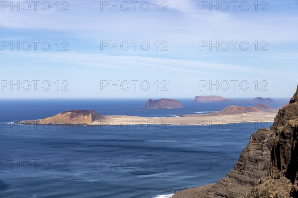 Wide view of several islands in the ocean, surrounded by blue sky, Canary Islands, Lanzarote, Spain, Europe