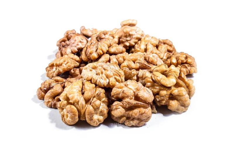Pile of walnuts isolated on white background. Closeup