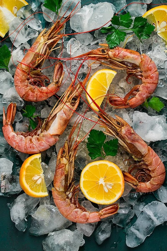 Tiger prawns, boiled and frozen, on ice, top view, close-up, no people