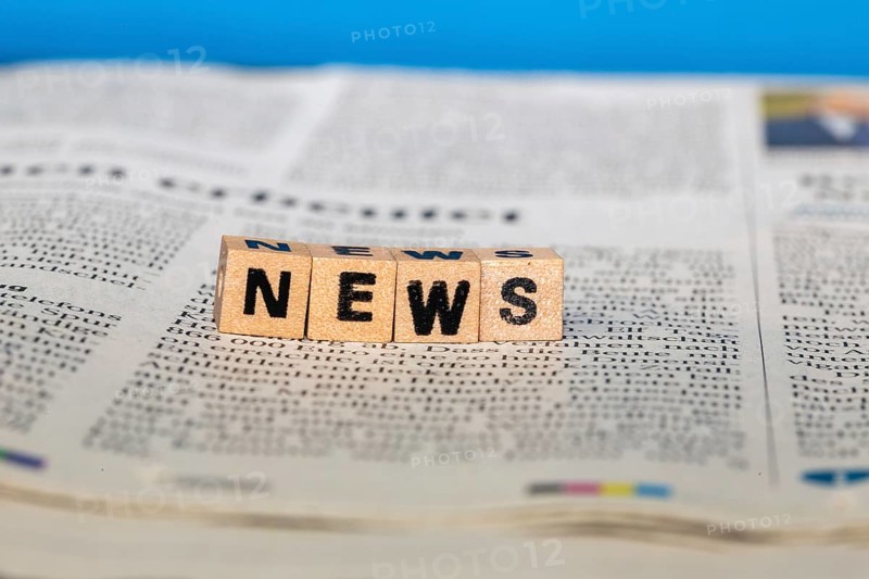 Symbolic image NEWS: Letter cube on a newspaper