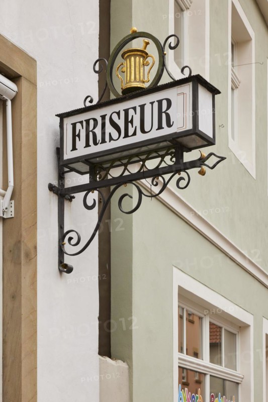 Historical sign for a hairdresser on a house in Warendorf, district of Warendorf, North Rhine-Westphalia, Germany, Europe