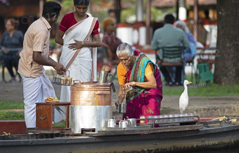 Tealady, 83 years old, making Indian tea on her boat, Backwaters, Kumarakom, Kerala, India, Asia