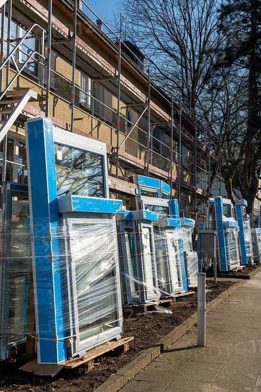 Energy-efficient refurbishment of residential buildings, older apartment block is scaffolded, gets thermal insulation and new windows, Germany, Europe