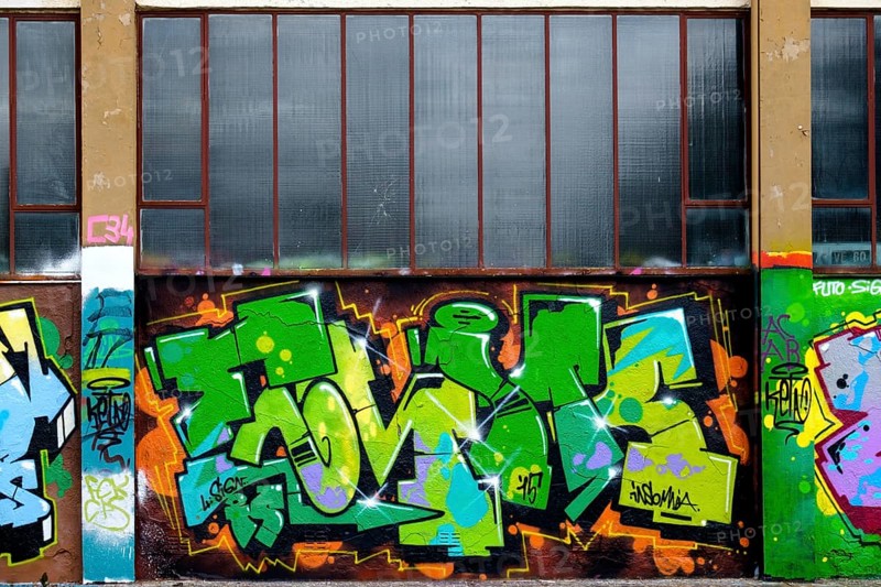 Colourful graffiti in shades of green and orange below windows, Landau, Rhineland-Palatinate, Germany, Europe