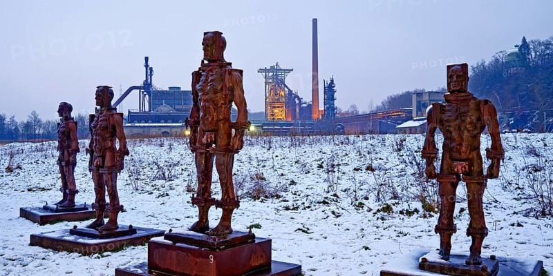 People made of iron, multi-part iron sculpture by Zbigniew Fraczkiewicz in front of the Henrichshütte in winter, Hattingen, Ruhr area, Germany, Europe