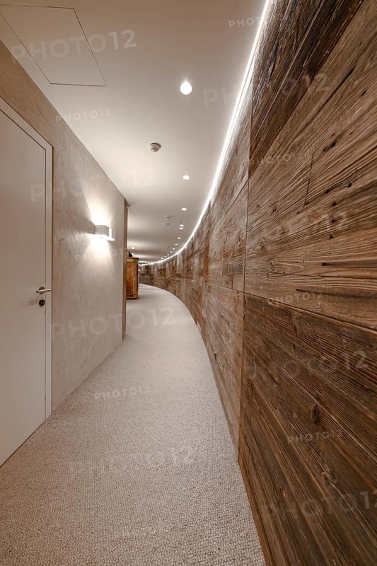 A long curved corridor with wooden panelling and modern lighting, Mayrhofen, Zillertal, Austria, Europe