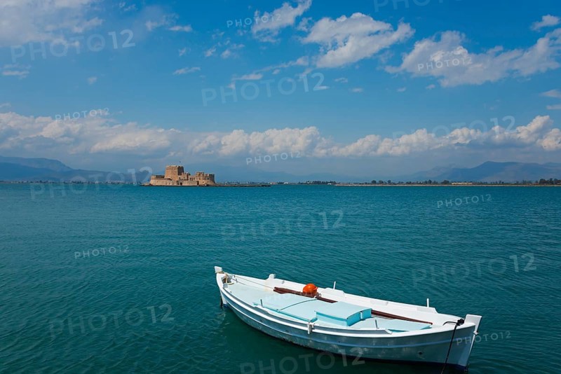A small fishing boat in calm waters with an island in the background, Fortress, Bourtz Island, Bourtsi, Nafplio, Nafplio, Nafplion, Nafplion, Argolis, Argolic Gulf, Peloponnese, Greece, Europe