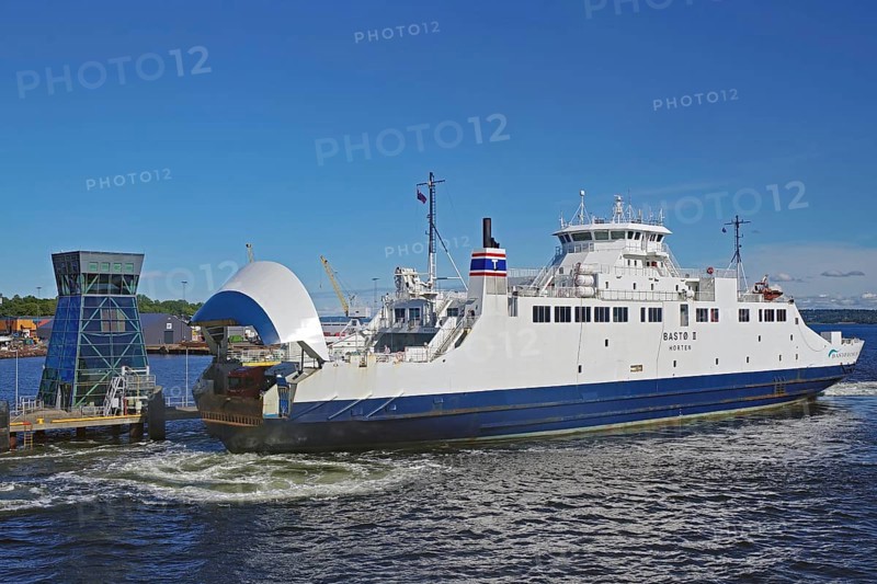 A large ferry docks in the harbour under a blue sky, electric ferry, Horten, Oslofjord, Norway, Europe