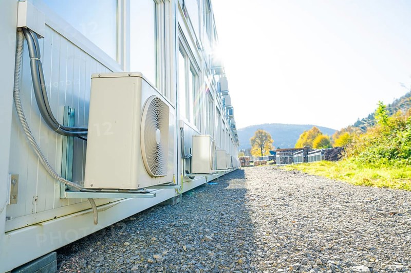 Side view of containers with air conditioning, in the background nature and sun, refugee accommodation Beermiß, Calmbach, Black Forest, Germany, Europe