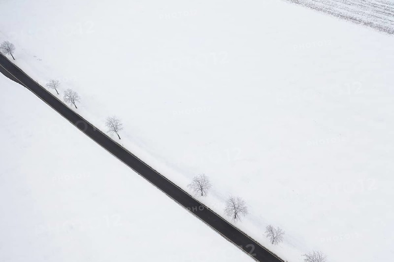 Aerial view of a straight country road in the snow, near Oederan, Saxony, Germany, Europe