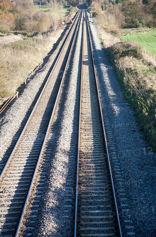 High angle view two sets of railway lines going off into the distance on the West Coast mainline at Woodborough, Wiltshire, England, UK