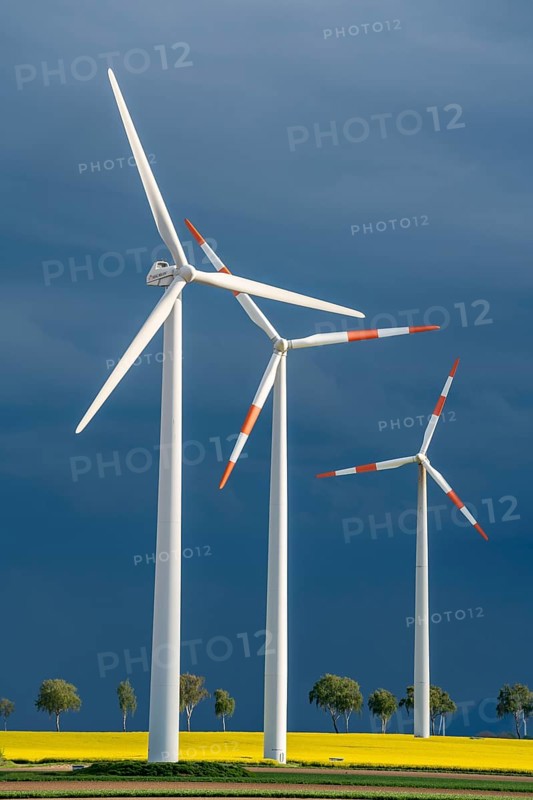 Wind turbines on a rape field, dark rain clouds, in the Rhenish lignite mining area, near Erkelenz-Holzweiler