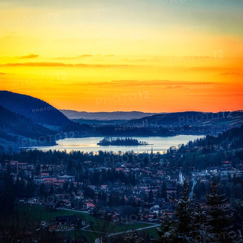 Idyllic landscape with lake and mountains at sunset, quiet village and bright sky, Schliersee