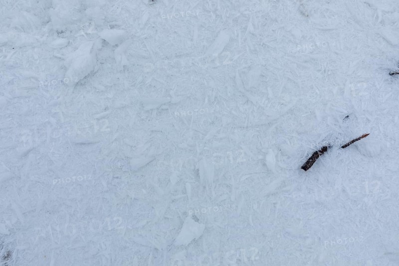 Ice crystals from the hoarfrost, blown by the wind from the trees, lie on the snow on the summit of the Czorneboh, Lusatian Mountains, Upper Lusatia, Saxony, Germany, Europe