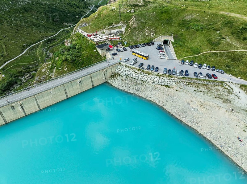 Dam of the Moiry lake, Lac de Moiry, turquoise glacial water, parking lot and restaurant at the dam, aerial view, Valais, Switzerland, Europe
