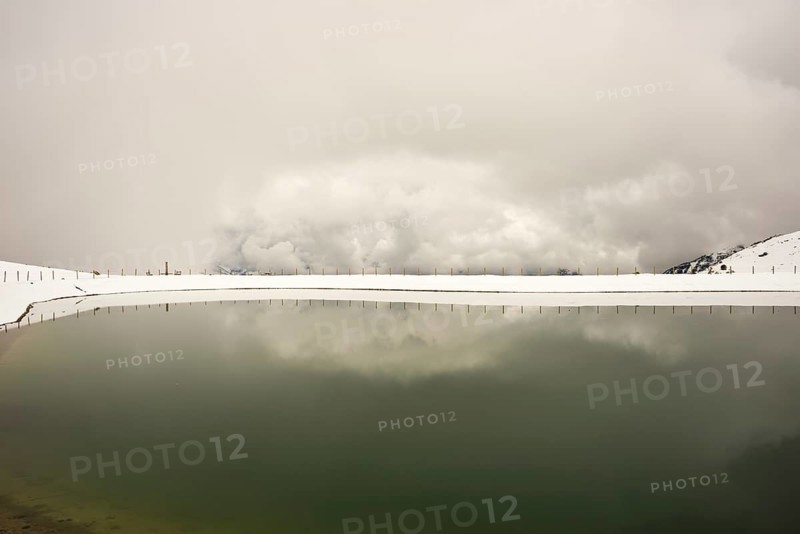 Onset of winter in May, Riezler Alpsee, an artificial lake, snow pond, feeds the snow cannons that provide the slopes of the Fellhorn and Kanzelwand cable cars with snow, Allgäu Alps, Vorarlberg, Austria, Europe