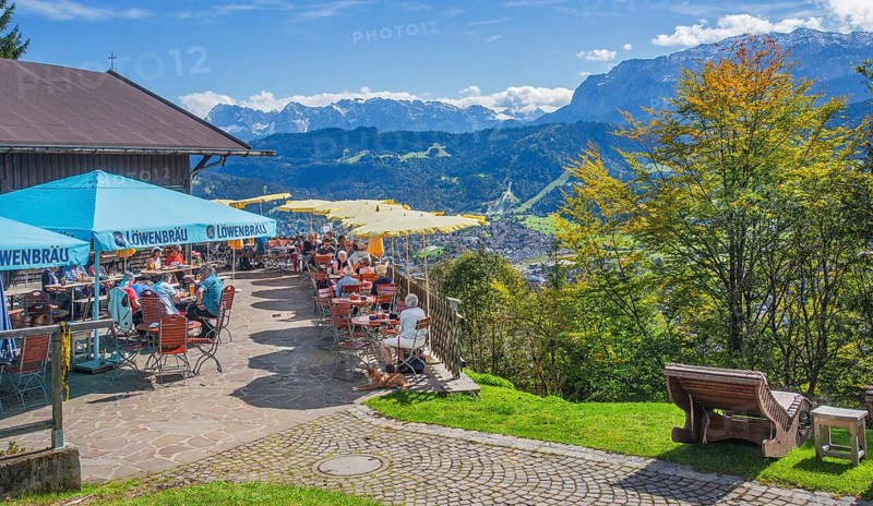 St. Martinshütte with restaurant terrace overlooking the valley with the Karwendel and Wetterstein mountains, Garmisch-Partenkirchen, Loisachtal, Werdenfelser Land, Upper Bavaria, Bavaria, Germany, Europe