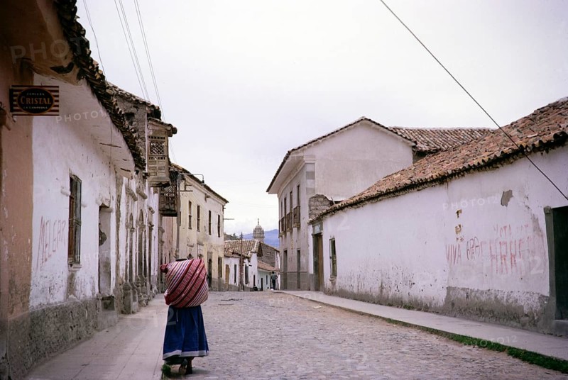 Street scene in Ayacucho, Peru, South America 1962 Indigenous woman walking with a load on her back, South America