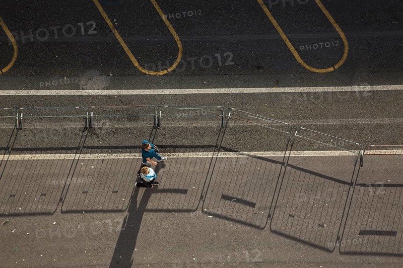 Top view of two middle aged women walking along a asphalt road surface in the port of La Spezia, Italy, Europe