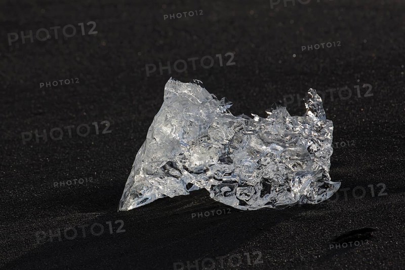 Little icebergs and crushed ice on the black beach at Joekulsarlon glacial lake