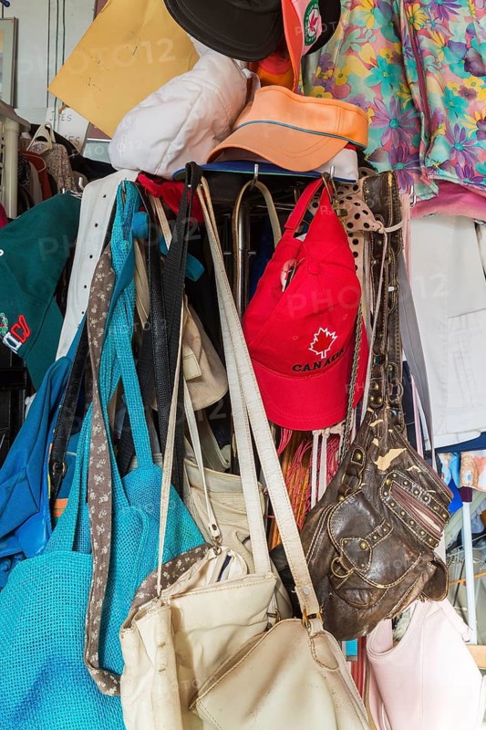Handbags and caps for sale inside second hand goods and chattels store, Quebec, Canada, North America