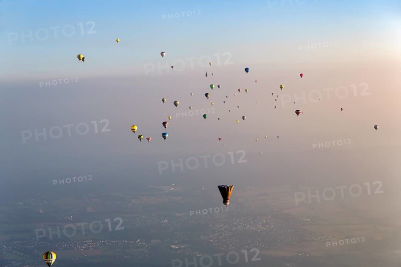 Many different hot air balloons on the way in the blue sky, distance, hot air balloon festival, 26th Warsteiner International Montgolfiade, evening haze, aerial view, Warstein, Sauerland, North Rhine-Westphalia, Germany, Europe