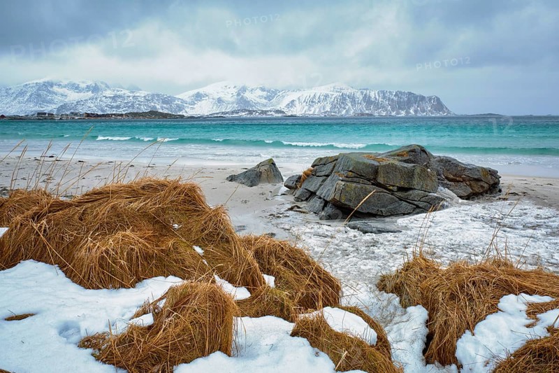 Waves of Norwegian sea on rocky beach of fjord. Ramberg beach, Lofoten islands, Norway, Europe