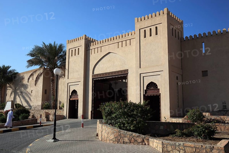 Entrance gate of Nizwa Fort. Nizwa is the centre of the Omani heartland. The oasis city lies on the southern edge of the Hajar Mountains near the Jabal al-Achdar, the highest mountain range in Oman