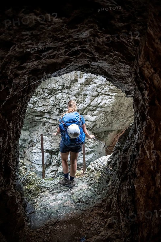 Hiker in a tunnel, Hammersbach flows through Höllentalklamm, near Garmisch-Partenkirchen, Werdenfelser Land, Upper Bavaria, Bavaria, Germany, Europe