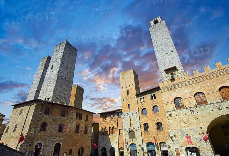 The Piazza Duomo (Cathedral Square) of San Gimignano with its medieval towers built as defensive towers and also to show the families wealth by the height of the tower. A UNESCO World Heritage Site. San Gimignano; Tuscany Italy