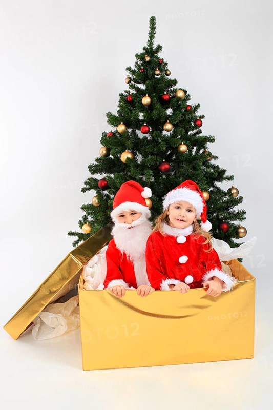 Children dressed up as Santa Claus, in big gift, on the Christmas tree, decorated Christmas tree, Santa Claus, Santa Claus, Santa Claus costume