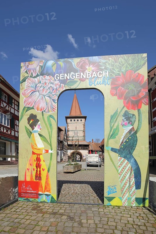View to the historic Obertorturm through the main street with a poster and inscription to Gengenbach blossoms, Ortenau, Southern Black Forest, Black Forest, Baden-Württemberg, Germany, Europe