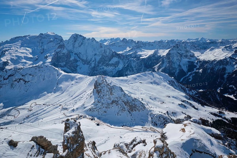 View of a ski resort piste and Dolomites mountains in Italy from Passo Pordoi pass. Arabba, Italy, Europe