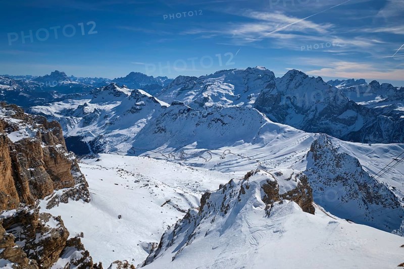 View of a ski resort piste and Dolomites mountains in Italy from Passo Pordoi pass. Arabba, Italy, Europe