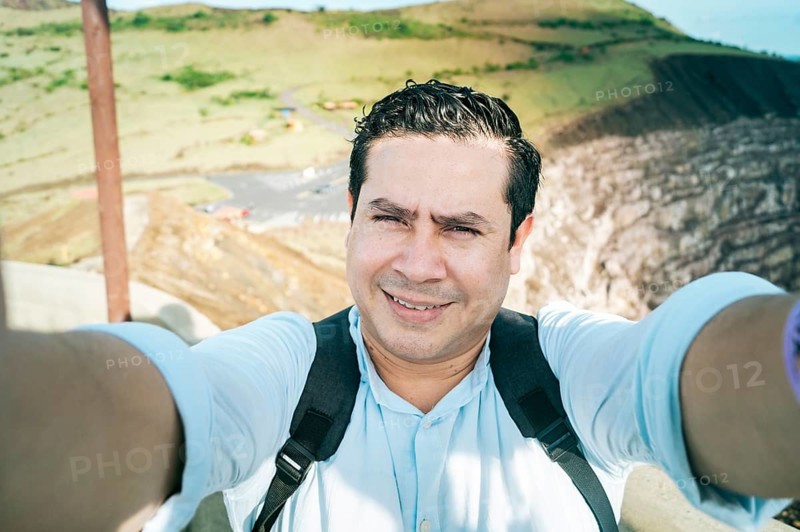 Close up of man taking an adventure selfie, Tourist taking a selfie at a viewpoint. Adventurous people taking a selfie at a viewpoint. Handsome tourist taking a selfie on vacation
