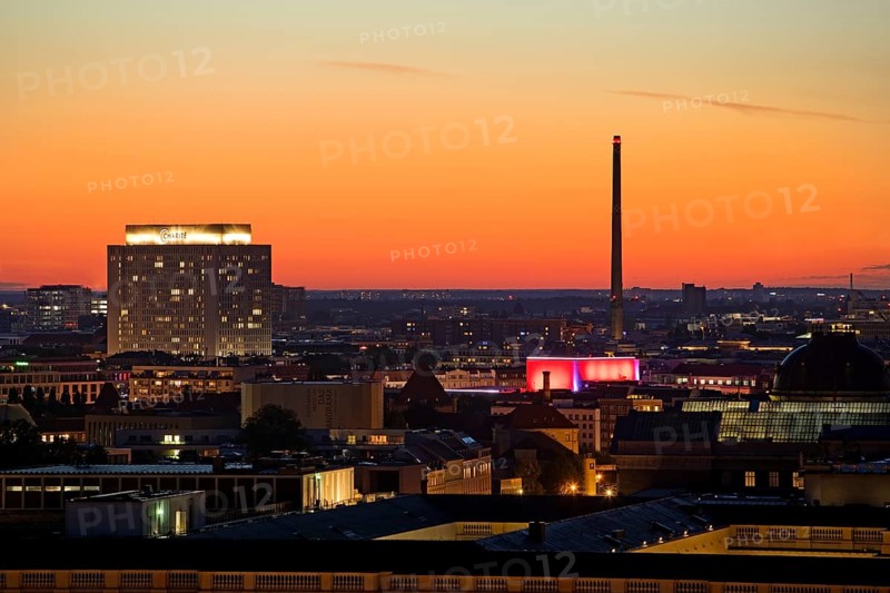 Charité high-rise hospital and the chimney of the Vattenfall combined heat and power plant Scharnhorststraße in the sunset, Berlin, Germany, Europe