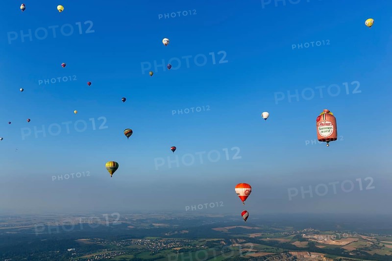 Many different hot air balloons in the blue sky, advertising, logo, hot air balloon festival, 26th Warsteiner International Montgolfiade, evening haze, aerial view, Warstein, Sauerland, North Rhine-Westphalia, Germany, Europe