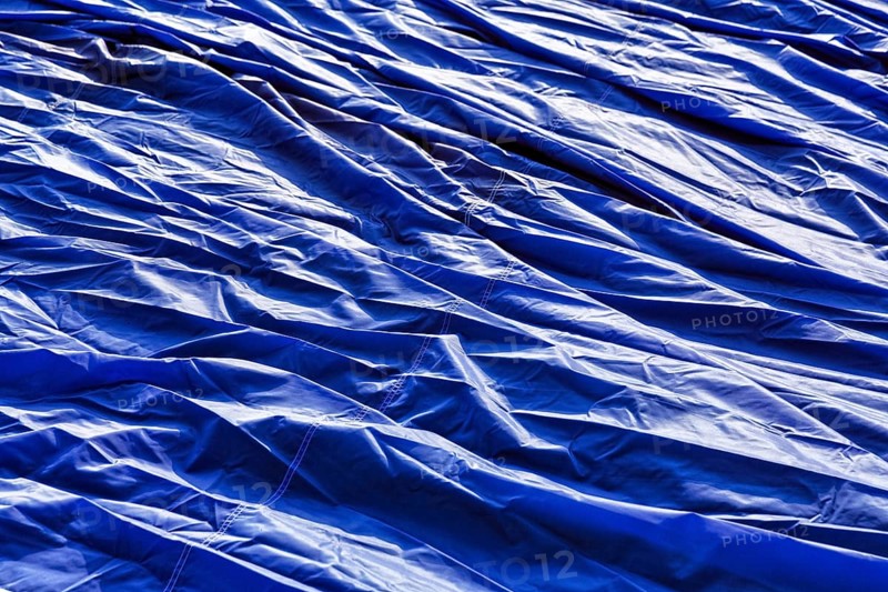 Blue balloon envelope, hot air balloon lying on the ground, preparation for hot air balloon festival, Warsteiner International Mountain Golfiade, Warstein, Sauerland, North Rhine-Westphalia, Germany, Europe