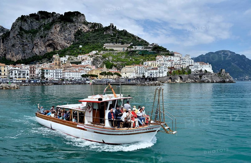 Tour boat in front of town Amalfi, Amalfi Coast, Costiera Amalfitana, Province of Salerno, Campania, Italy, Europe