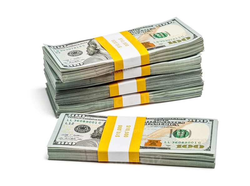 Creative business finance making money concept, stack of bundles of 100 US dollars 2013 edition banknotes bills isolated on white