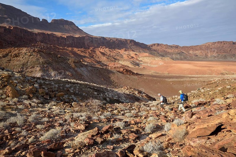 Hikers in the amphitheatre near De Riet, Huab Dry River, Kunene region, Namibia, Africa